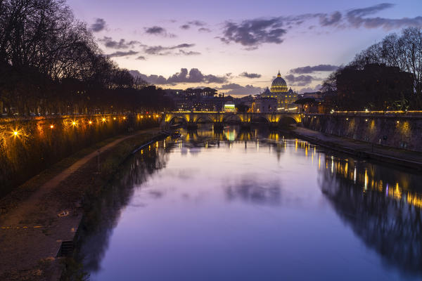 Dusk in Rome in front of the Basilica di San Pietro, Sant'Angelo bridge and the river Tevere from Umberto I bridge. Rome, Rome district, Lazio, Europe, Italy.