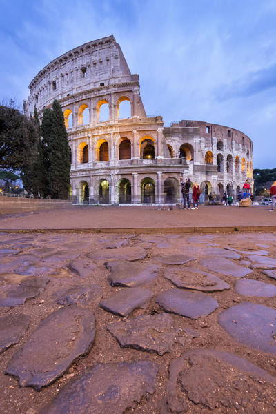 View of the Colosseum during a winter evening from the Via Sacra. Rome, Lazio, Italy. 