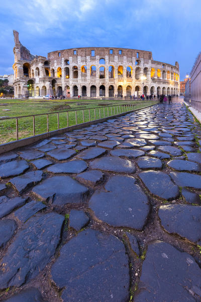 View of the Colosseum during a winter evening from the Via Sacra. Rome, Lazio, Italy. 