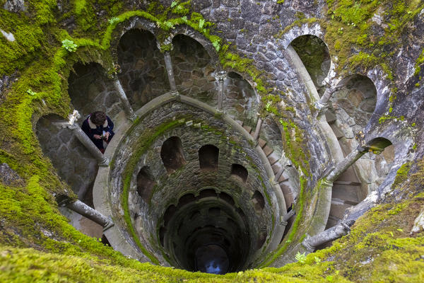View from above of the spiral stairs inside the inverted tower, called also initiation well, at Quinta da Regaleira Palace, Sintra, Portugal, Europe.