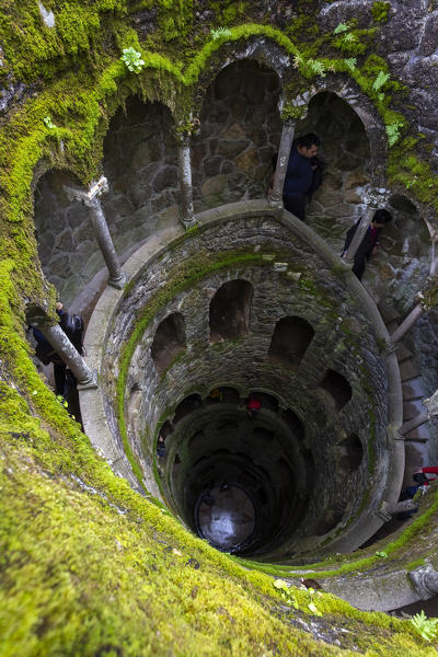 View from above of the spiral stairs inside the inverted tower, called also initiation well, at Quinta da Regaleira Palace, Sintra, Portugal, Europe.