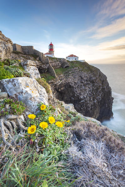 The cliffs and lighthouse of Cabo De San Vicente at sunset, overlooking the Atlantic Ocean. Sagres, Vila do Bispo, Algarve, Portugal, Europe.