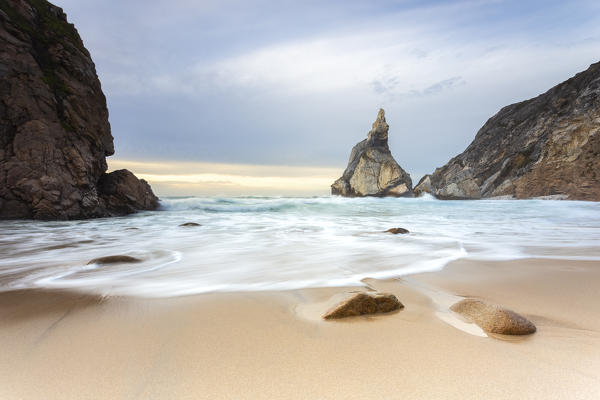 Sunset on the beach of Praia da Ursa,with the giant Ursa and Gigante boulders. Cabo da Roca, Colares, Sintra, Portugal, Europe.