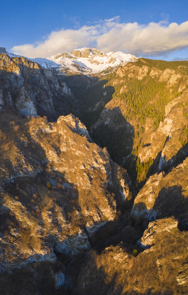 Aerial view of narrow Valle dei Mulini in Rusio and the Presolana during a winter sunset. Rusio, Castione della Presolana, Val Seriana, Bergamo district, Lombardy, Italy.