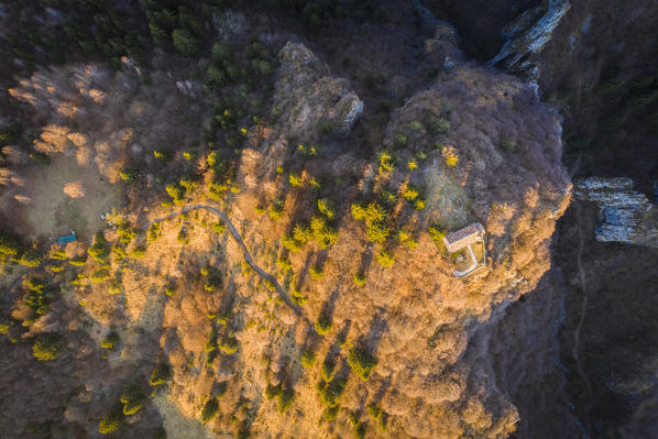 View from above of the small church called San Peder during a winter sunset. Rusio, Castione della Presolana, Val Seriana, Bergamo district, Lombardy, Italy.