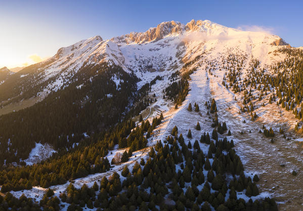 Aerial view of the Presolana covered in snow and the Cassinelli refuge during a winter sunset. Cantoniera della Presolana, Passo della Presolana, Castione della Presolana, Val Seriana, Bergamo district, Lombardy, Italy.