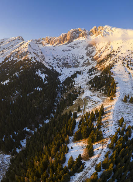 Aerial view of the Presolana covered in snow and the Cassinelli refuge during a winter sunset. Cantoniera della Presolana, Passo della Presolana, Castione della Presolana, Val Seriana, Bergamo district, Lombardy, Italy.