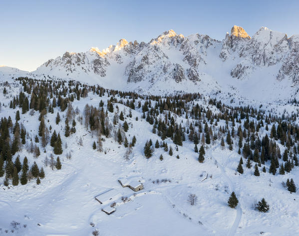 Aerial view of a mountain hut at the Campelli di Schilpario and the Cimone della Bagozza covered in snow in winter. Schilpario, Val di Scalve, Bergamo district, Lombardy, Italy, Southern Europe.