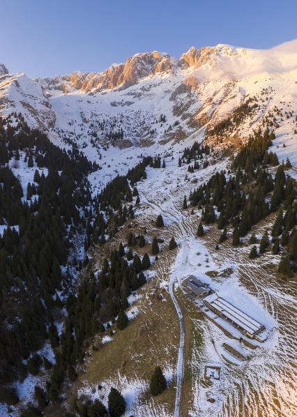 Aerial view of the Presolana covered in snow and the Cassinelli refuge during a winter sunset. Castione della Presolana, Val Seriana, Bergamo district, Lombardy, Italy.