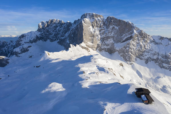 Aerial view of the snow-covered north face of the Presolana mountain and the Rifugio Aquila in winter. Val di Scalve, Bergamo district, Lombardy, Italy, Southern Europe.