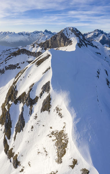 Aerial view of the top of the Monte Ferrante and Monte Ferrantino covered in snow in winter. Val di Scalve, Bergamo district, Lombardy, Italy, Southern Europe.