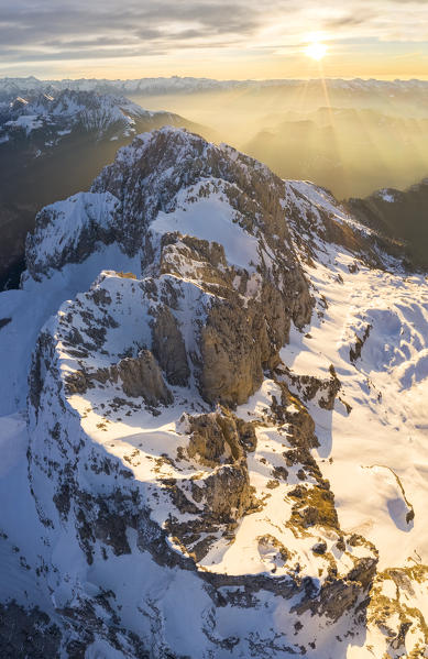 Aerial panorama of the snow-covered Presolana mountain from above in winter at sunrise. Val di Scalve, Bergamo district, Lombardy, Italy, Southern Europe.