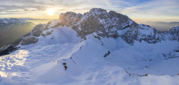 Aerial panorama of the snow-covered north face of the Presolana mountain in winter. Val di Scalve, Bergamo district, Lombardy, Italy, Southern Europe.