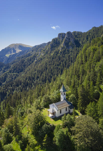 Aerial view of the Silvestri church and the Mount Pora in a summer day. Presolana pass, Angolo Terme, Seriana Valley, Brescia province, Lombardy, Italy.