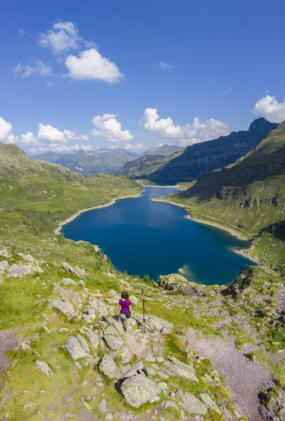 Aerial view of a tourist admiring the Laghi Gemelli from the Laghi Gemelli pass. Branzi, Val Brembana, Alpi Orobie, Bergamo, Bergamo Province, Lombardy, Italy, Europe.