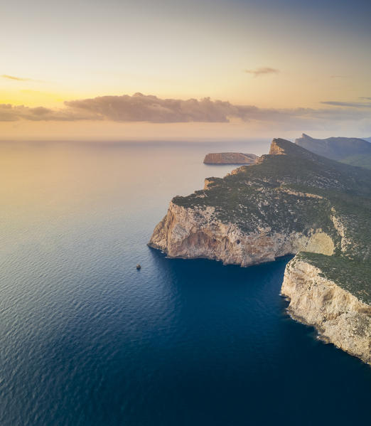 Aerial view of the rocky promontory of Capo Caccia at sunset, Alghero,  Sassari district, Sardinia, Italy.