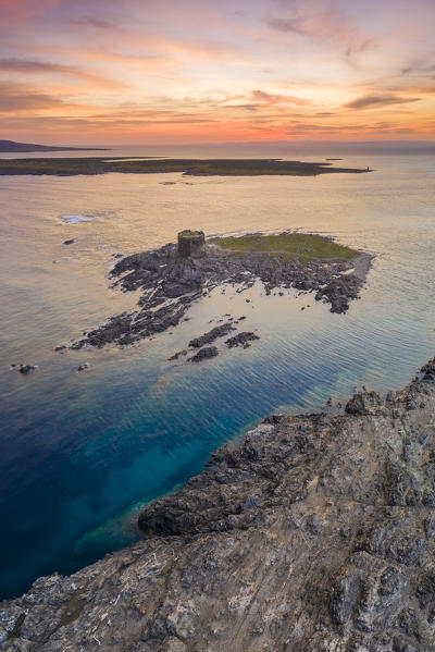 Aerial view of the small island and the medieval tower of La Pelosa and Isola Piana at dawn, Stintino, Asinara Gulf, Sassari district, Sardinia, Italy.