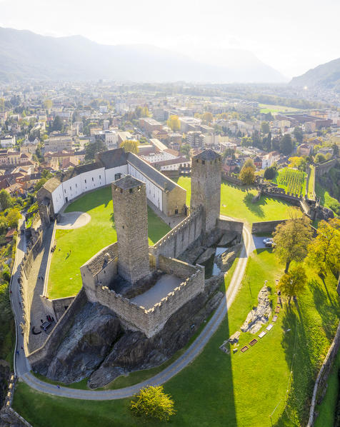 Aerial view of the medieval Bellinzona castles, Unesco World Heritage site, in autumn at sunset. Canton Ticino, Switzerland.