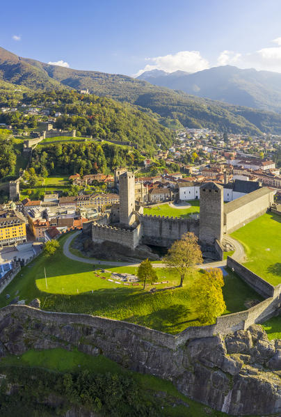 Aerial view of the medieval Bellinzona castles, Unesco World Heritage site, in autumn at sunset. Canton Ticino, Switzerland.