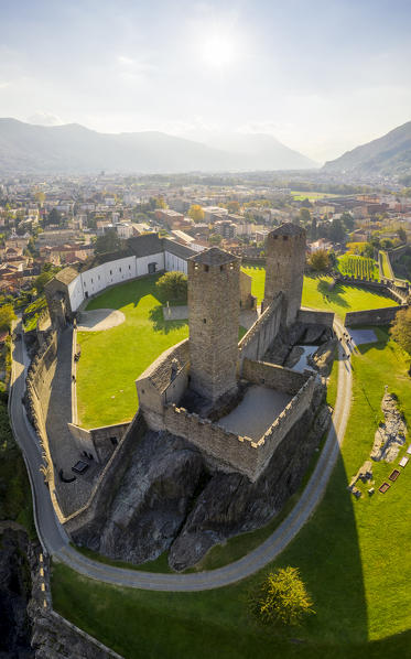 Aerial view of the medieval Bellinzona castles, Unesco World Heritage site, in autumn at sunset. Canton Ticino, Switzerland.