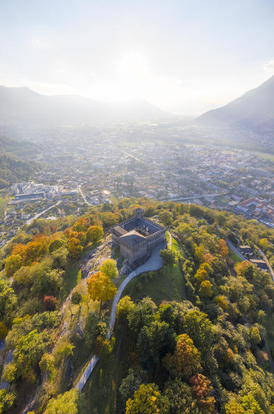 Aerial view of the medieval Bellinzona castles, Unesco World Heritage site, in autumn at sunset. Canton Ticino, Switzerland.