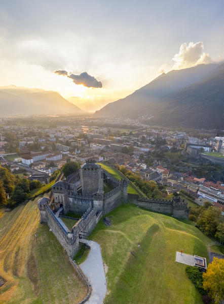Aerial view of the medieval Bellinzona castles, Unesco World Heritage site, in autumn at sunset. Canton Ticino, Switzerland.