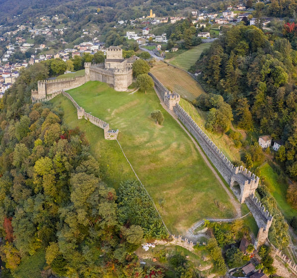 Aerial view of the medieval Bellinzona castles, Unesco World Heritage site, in autumn at sunset. Canton Ticino, Switzerland.
