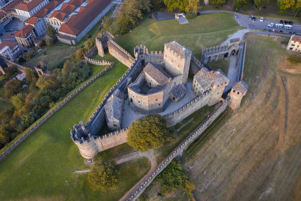 Aerial view of the medieval Bellinzona castles, Unesco World Heritage site, in autumn at sunset. Canton Ticino, Switzerland.