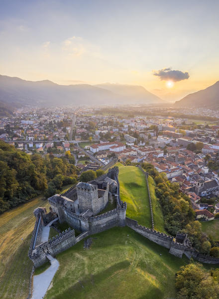 Aerial view of the medieval Bellinzona castles, Unesco World Heritage site, in autumn at sunset. Canton Ticino, Switzerland.