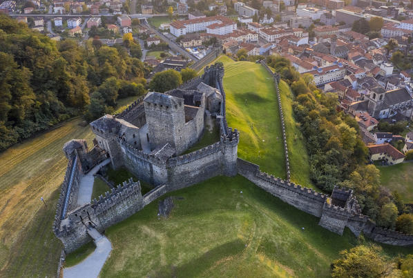 Aerial view of the medieval Bellinzona castles, Unesco World Heritage site, in autumn at sunset. Canton Ticino, Switzerland.