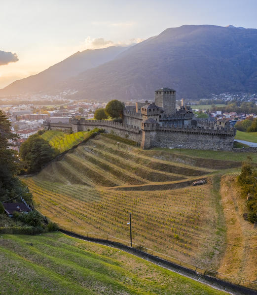 Aerial view of the medieval Bellinzona castles, Unesco World Heritage site, in autumn at sunset. Canton Ticino, Switzerland.