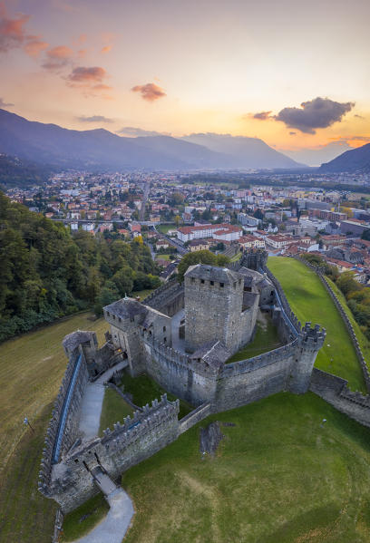 Aerial view of the medieval Bellinzona castles, Unesco World Heritage site, in autumn at sunset. Canton Ticino, Switzerland.