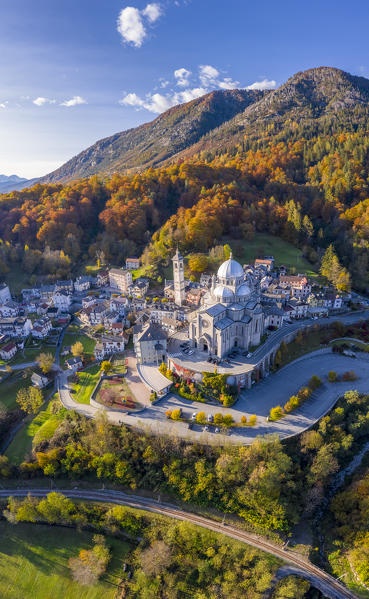 Aerial view of the Santuario della Madonna del Sangue sanctuary in the town of Re during an autumnal sunset. Re, Valle Vigezzo, val d'Ossola, Verbano Cusio Ossola, Piedmont, Italy.