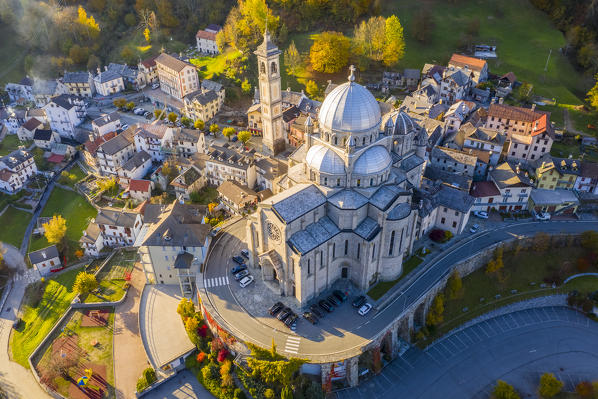 Aerial view of the Santuario della Madonna del Sangue sanctuary in the town of Re during an autumnal sunset. Re, Valle Vigezzo, val d'Ossola, Verbano Cusio Ossola, Piedmont, Italy.