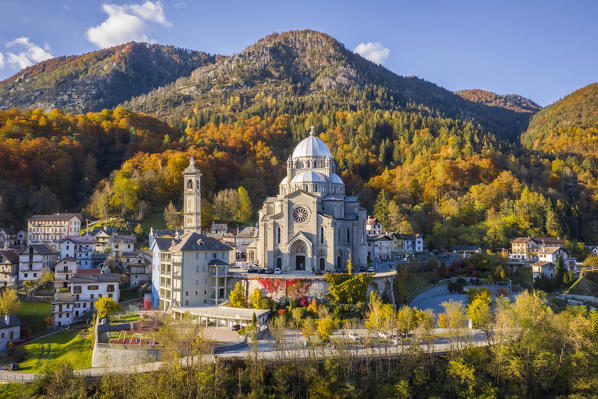 Aerial view of the Santuario della Madonna del Sangue sanctuary in the town of Re during an autumnal sunset. Re, Valle Vigezzo, val d'Ossola, Verbano Cusio Ossola, Piedmont, Italy.