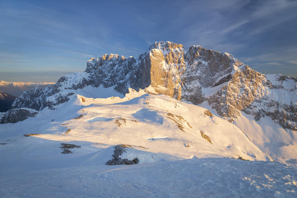 View of the snow-covered north face of the Presolana mountain in winter at sunset. Colere, Val di Scalve, Bergamo district, Lombardy, Italy, Southern Europe.