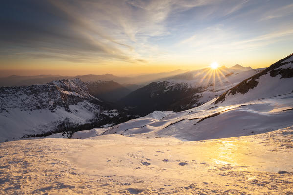 View of the snow-covered Scalve valley at sunrise from the foothills of Monte Ferrante. Colere, Val di Scalve, Bergamo district, Lombardy, Italy, Southern Europe.