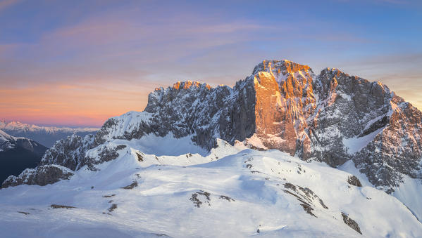 Panoramic view of the snow-covered north face of the Presolana mountain in winter at sunset. Colere, Val di Scalve, Bergamo district, Lombardy, Italy, Southern Europe.