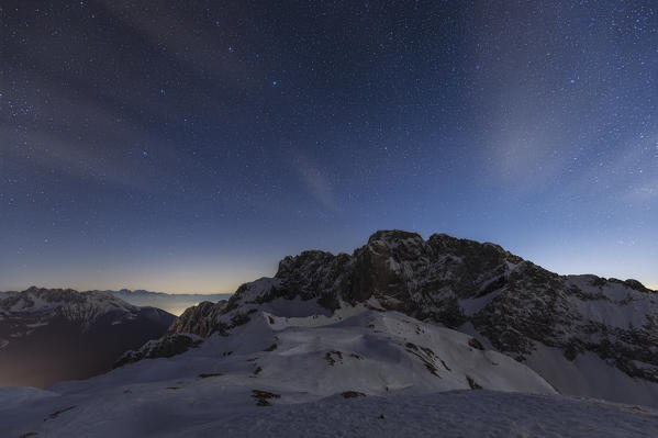 View of the snow-covered north face of the Presolana mountain in winter at night. Colere, Val di Scalve, Bergamo district, Lombardy, Italy, Southern Europe.
