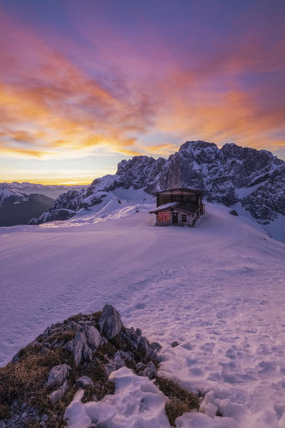 View of the snow-covered north face of the Presolana mountain in winter at sunrise with the Aquila refuge. Colere, Val di Scalve, Bergamo district, Lombardy, Italy, Southern Europe.