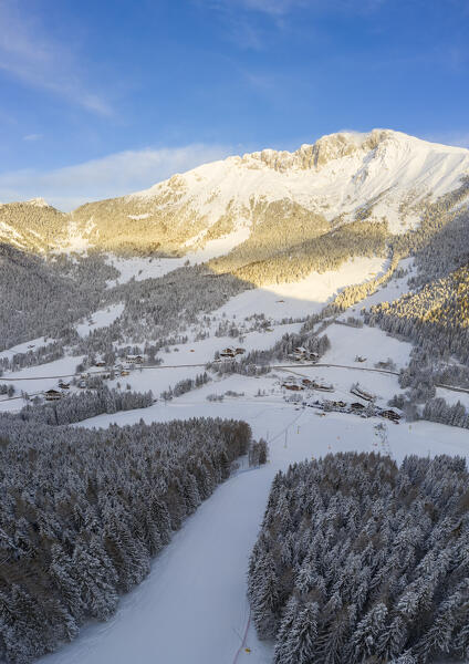 Aerial view of the ski slopes of the Presolana Pass and the Presolana massif after a winter sunrise. Presolana pass, Castione della Presolana, Seriana Valley, Bergamo province, Lombardy, Italy.