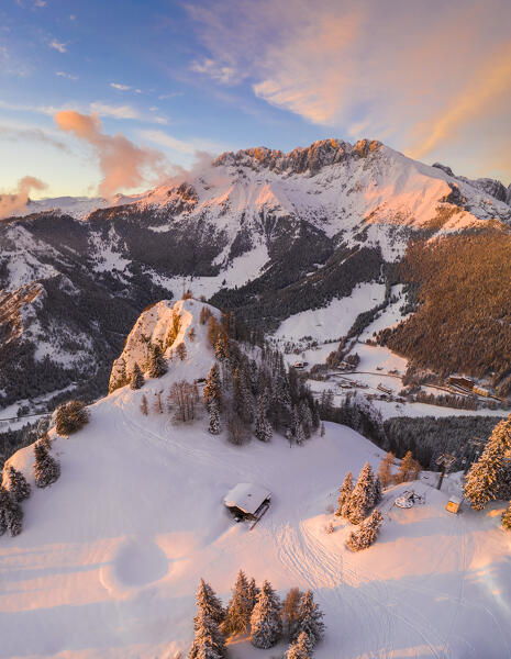 Aerial view of the Presolana covered in snow, Malga Scanapà and the iron cross from Mount Scanapà during a winter sunset. Castione della Presolana, Val Seriana, Bergamo district, Lombardy, Italy.