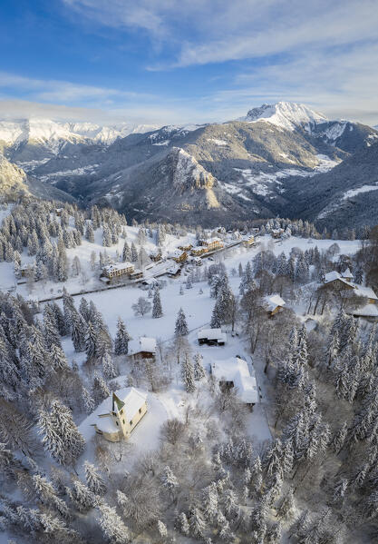 Aerial view of the Silvestri church, Presolana Pass and the Pizzo Camino after a winter sunrise. Presolana pass, Colere, Seriana Valley, Bergamo province, Lombardy, Italy.