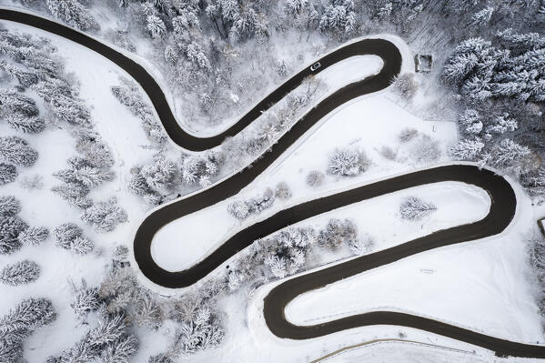 Aerial view of the winding road of the Presolana Pass after a winter snowfall. Presolana pass, Colere, Seriana Valley, Bergamo province, Lombardy, Italy.