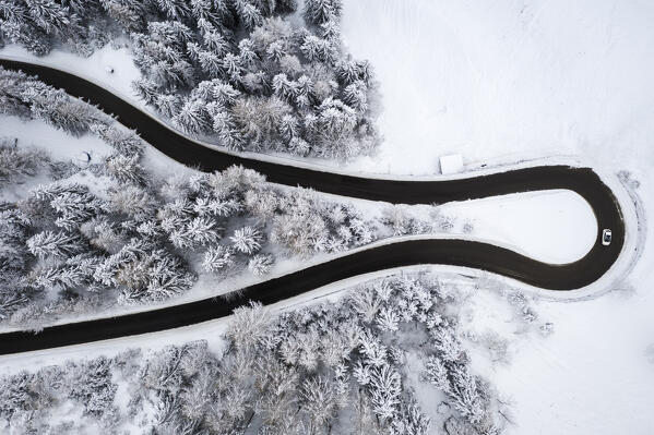 Aerial view of the winding road of the Presolana Pass after a winter snowfall. Presolana pass, Colere, Seriana Valley, Bergamo province, Lombardy, Italy.