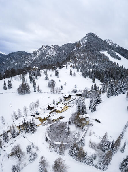 Aerial view of the houses along the Presolana Pass road and Monte Scanapà after a winter snowfall. Presolana pass, Colere, Seriana Valley, Bergamo province, Lombardy, Italy.