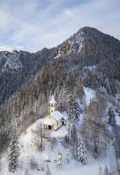 Aerial view of the Silvestri church and the Mount Scanapà during a winter sunrise. Presolana pass, Angolo Terme, Seriana Valley, Brescia province, Lombardy, Italy.
