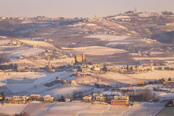 Winter sunset on the medieval town of Serralunga d'Alba and its castle viewed from La Morra. Serralunga d'Alba, Langhe, Piedmont, Italy, Europe.