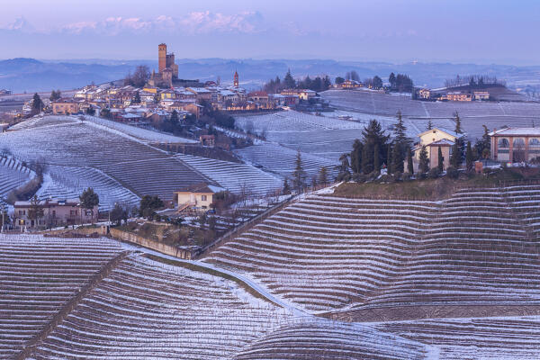 Blue hour on the medieval town of Serralunga d'Alba and its castle viewed from the surrounding vineyards. Serralunga d'Alba, Langhe, Piedmont, Italy, Europe.