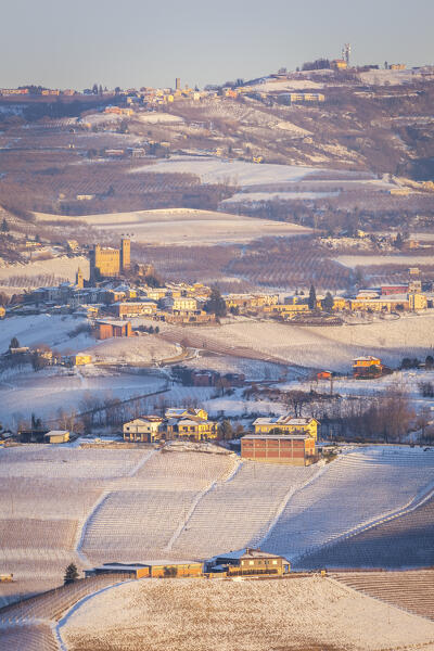 Winter sunset on the medieval town of Serralunga d'Alba and its castle viewed from La Morra. Serralunga d'Alba, Langhe, Piedmont, Italy, Europe.